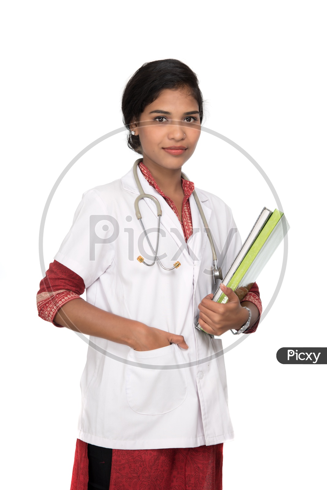 Young Lady Doctor With Stethoscope Over Neck And Holding Book In Hand On an Isolated White Background