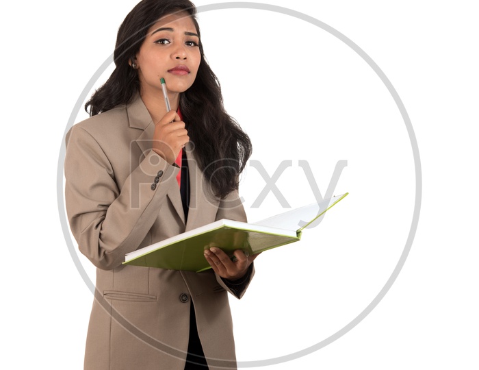 Young Indian business woman holding a book and a pen