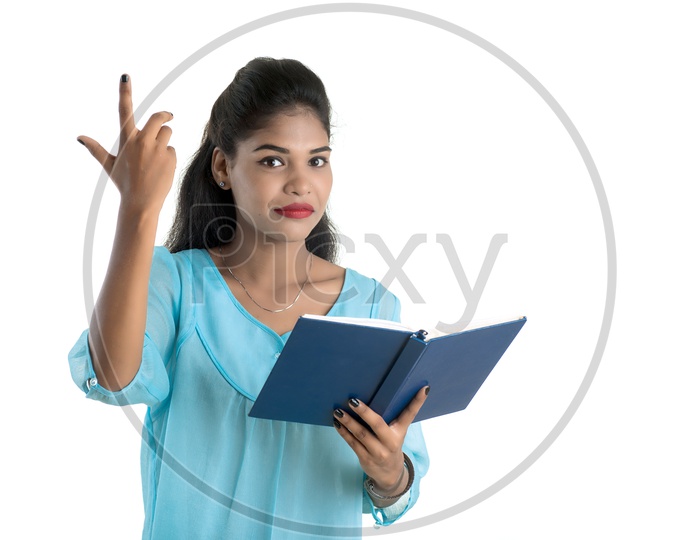 Pretty Young Girl Student Holding Book with Expression on her Face  and  Posing on an isolated White Background