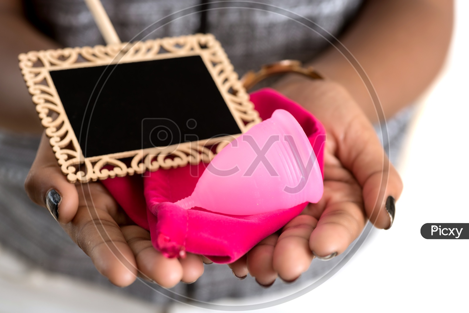 Menstrual Cup and a pouch in the hands of a Indian Woman