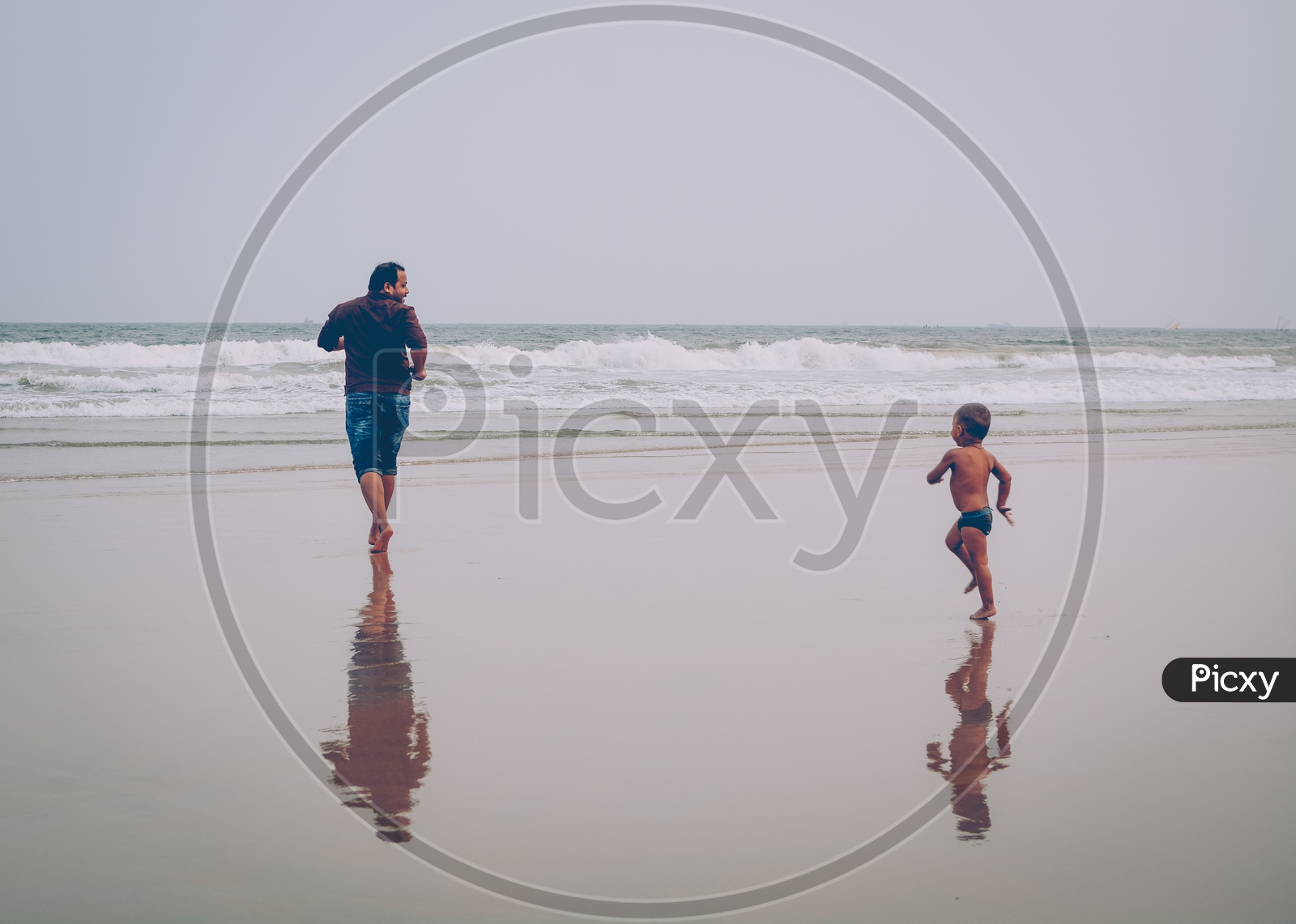 A Father And Sun Running In a Beach