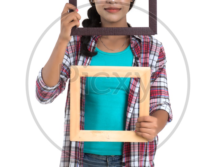 Attractive Young Indian Girl Posing With Empty Photo Frames on White Background