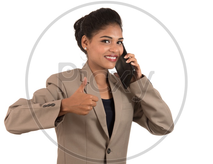Portrait Of a Happy and  Excited  Young Business Woman  Speaking on Mobile Phone or Smart Phone  over Isolated White Background