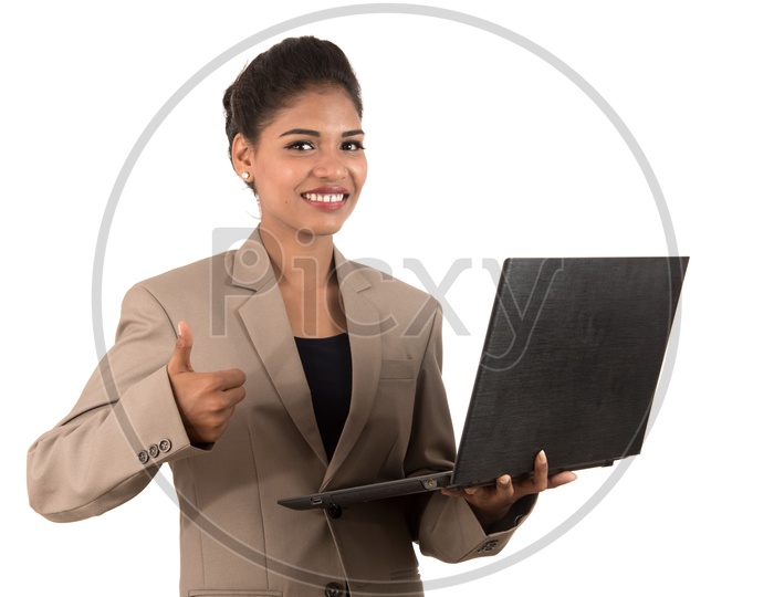 Young Indian business woman with a laptop making thumbs up sign