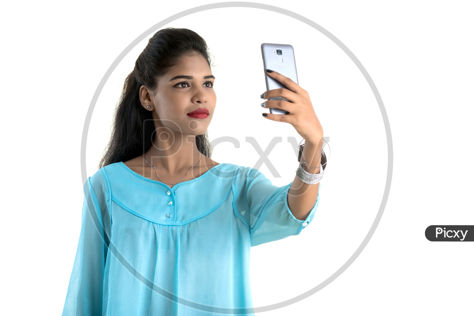 Portrait Of a Young Indian Girl Using Smart Phone Fr Taking Selfie   With a Smile Face On an Isolated White Background