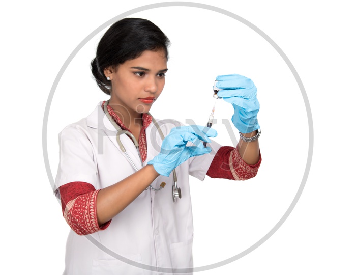 Indian Female Doctor loading a syringe