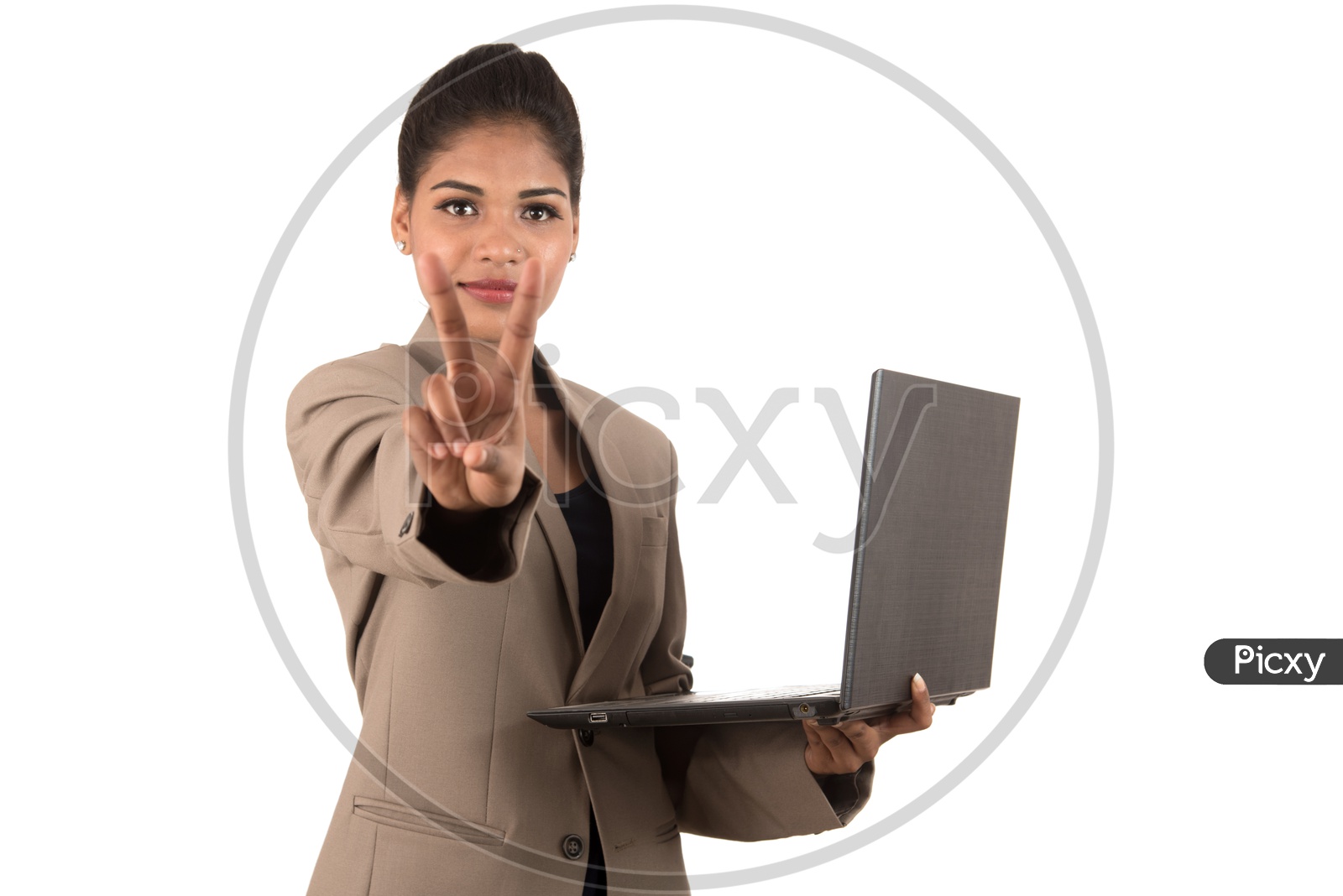 Young Indian business woman with a laptop making peace sign