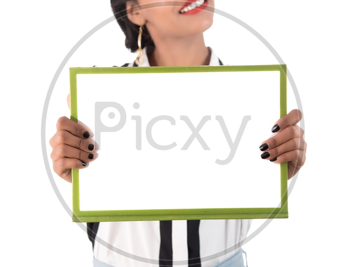 Young Indian Girl Showing The Empty Placard and Pointing The Empty Space on an Isolated White Background