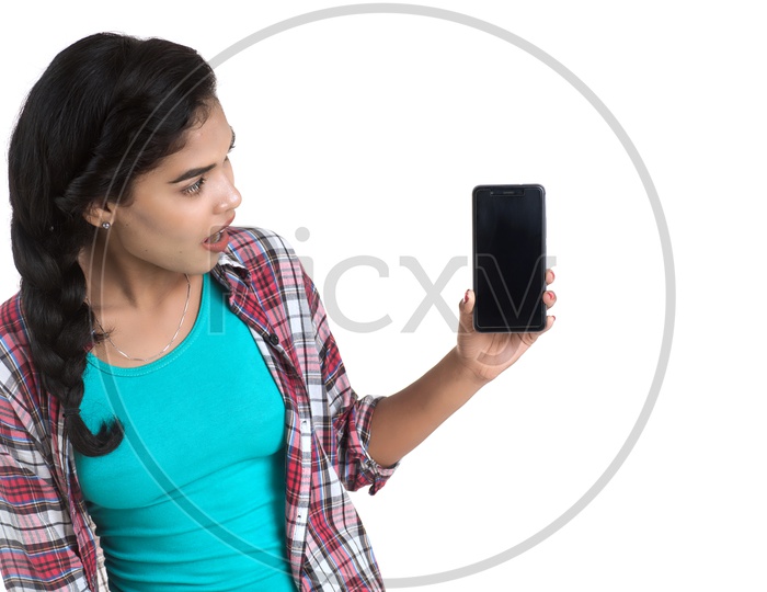 Pretty Indian Girl Showing Mobile Phone Screen and With a Expression On an Isolated White Background