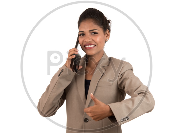 Smiling Indian business woman talking over a tablet phone