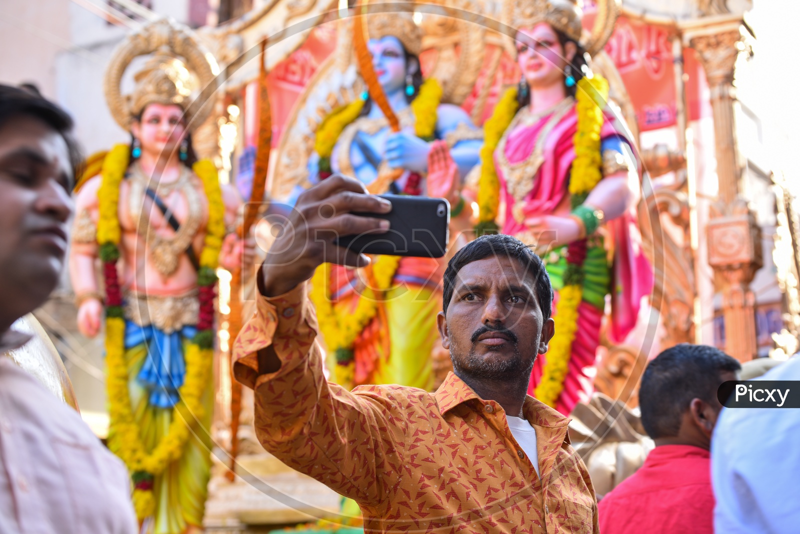 A man taking selfie with the Idols at Shri Rama Shobha yatra in Hyderabad