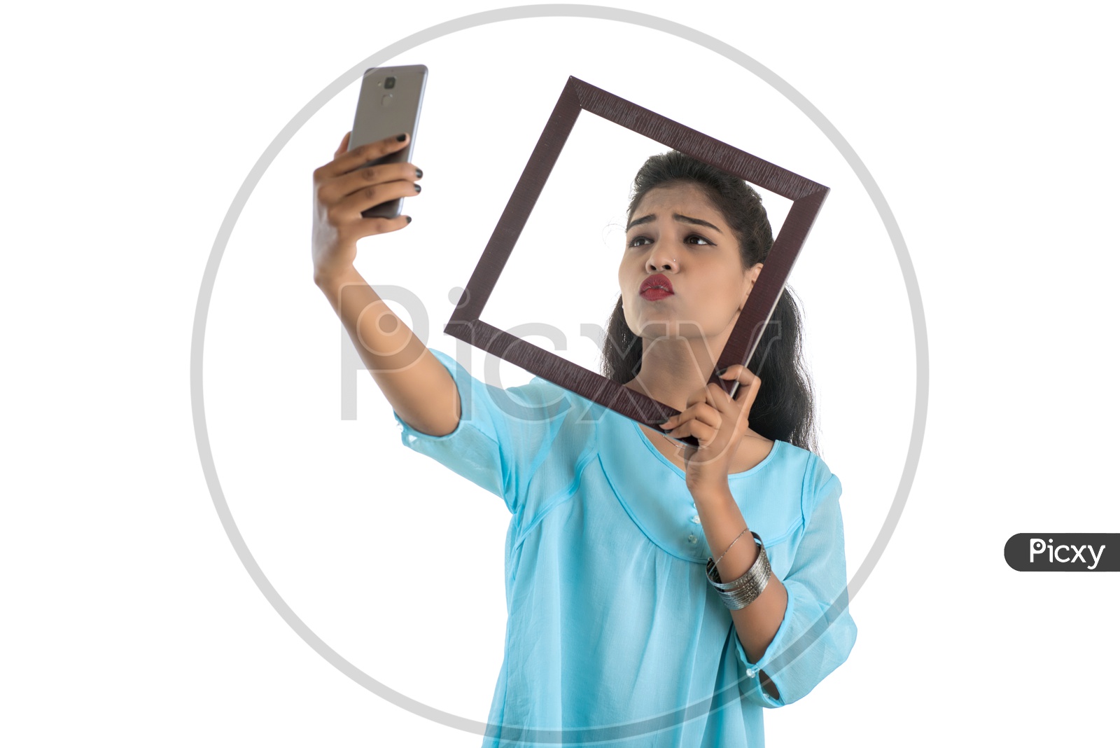 Pretty Young Indian Girl Taking Selfie Using Photo Fames in Her Smart Phone On an Isolated White Background