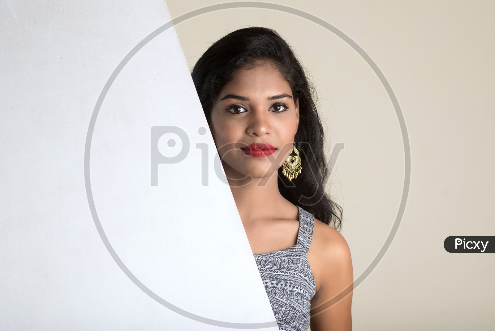 Indian woman holding an empty white board