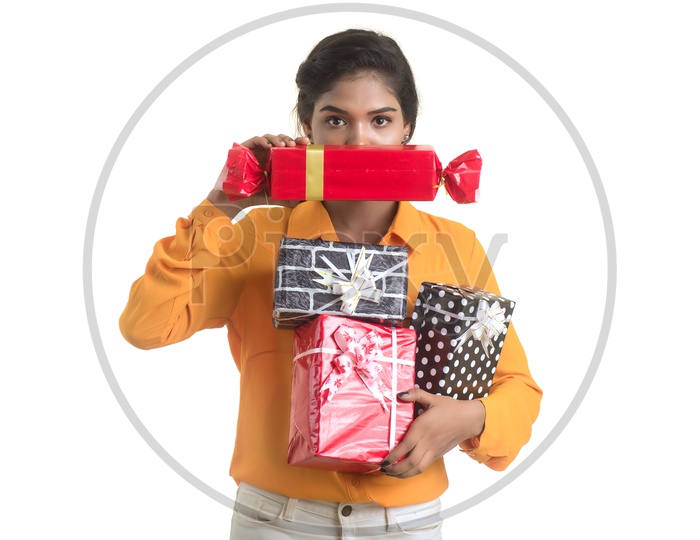 Young Girl Holding Gift Boxes  in Hand  with Smile On her Face On an Isolated White Background
