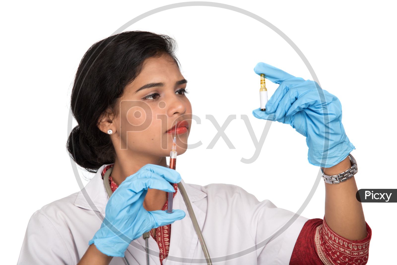 Indian Female Doctor loading a syringe from an ample