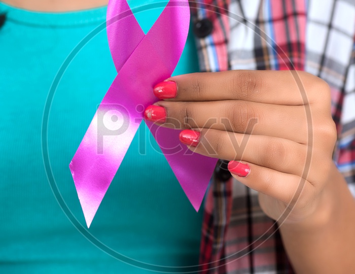 Young Woman Showing Red HIV Ribbon , AIDS Awareness Ribbon  on an  Isolated White Background