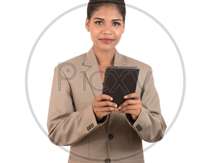 Smiling Indian business woman using a tablet smartphone