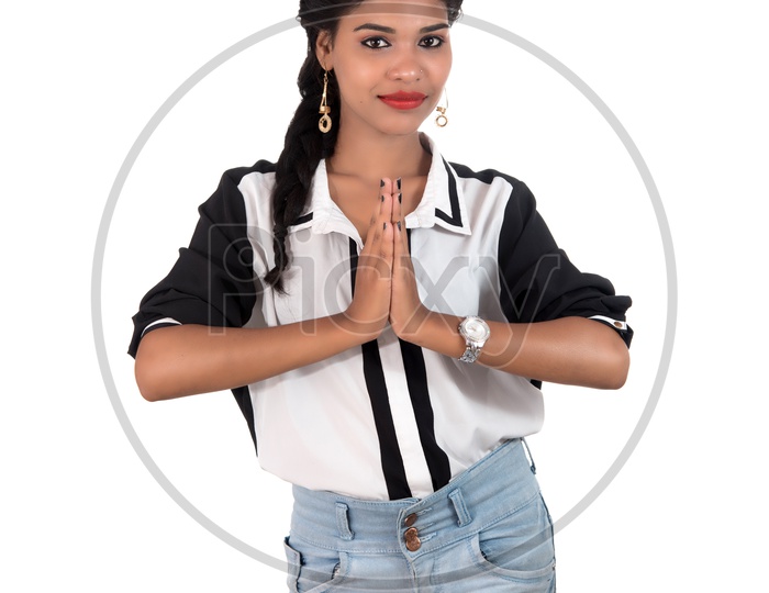 Young Beautiful Woman Showing Namaste  Gestures And Smile On Face On an Isolated White Background