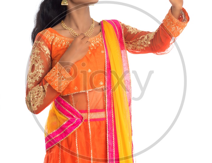 A young traditional Indian woman taking selfie using a mobile phone or smart phone