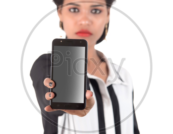 Young Indian Girl Showing Blank Smart Phone Screen and Posing On White Background