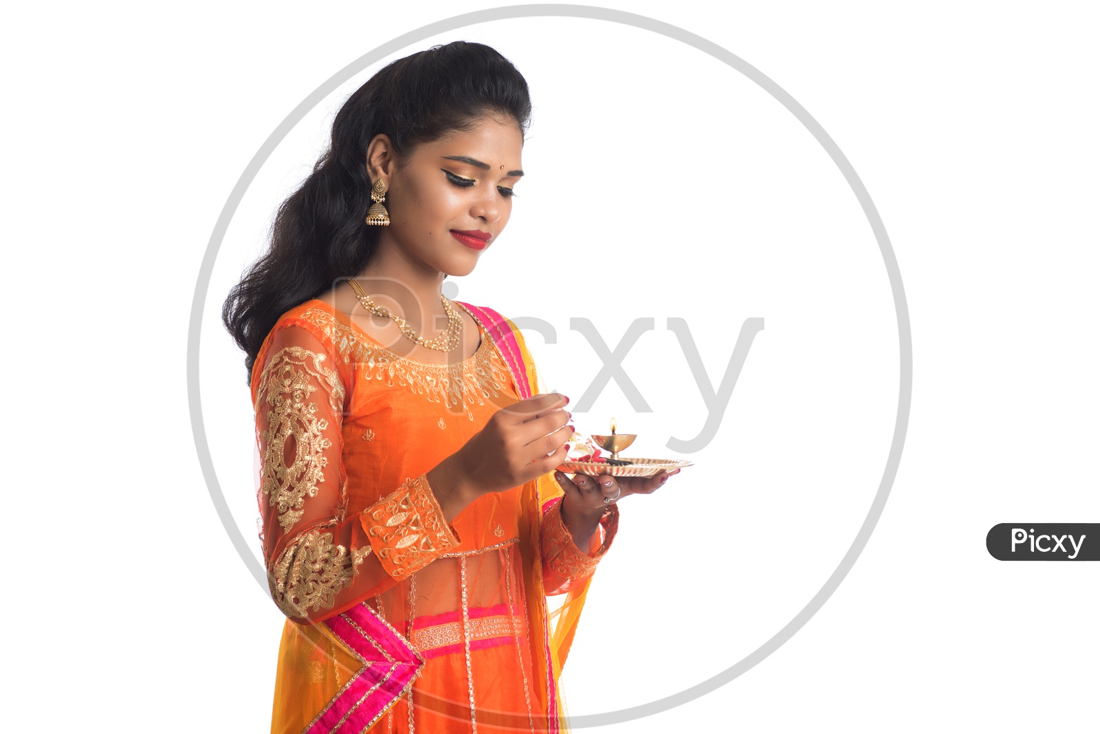 A Young Indian Traditional Woman With Pooja Thali Or Pooja Plates Holding In Hand and Performing Pooja With Smile Face On an Isolated White Background