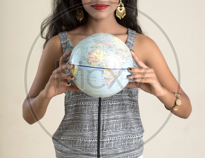 Indian woman holding a globe