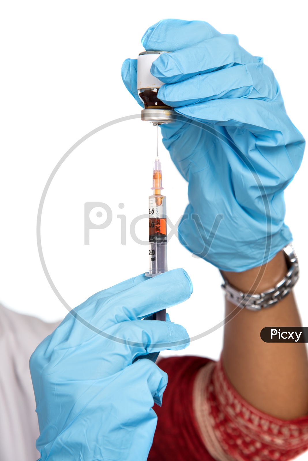 Indian Female Doctor loading a syringe from vial