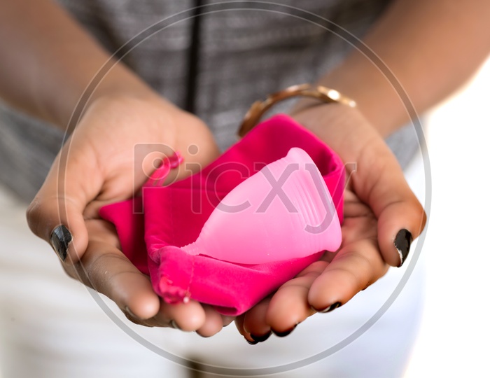Menstrual Cup and a pouch in the hands of a Indian Woman