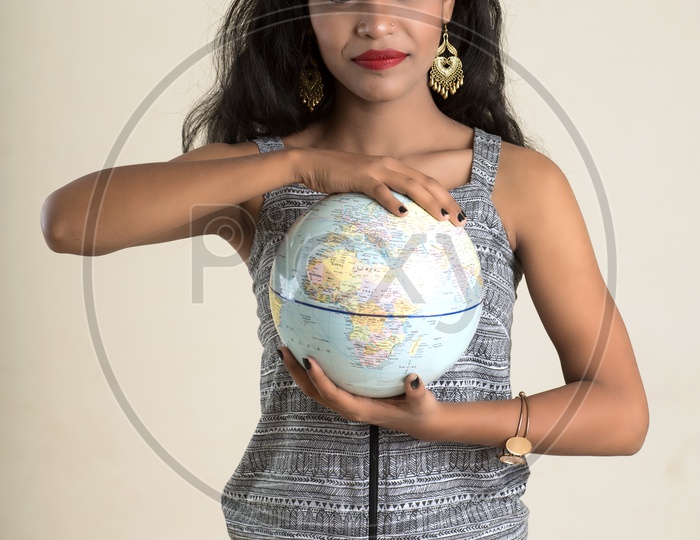 Indian woman holding a globe