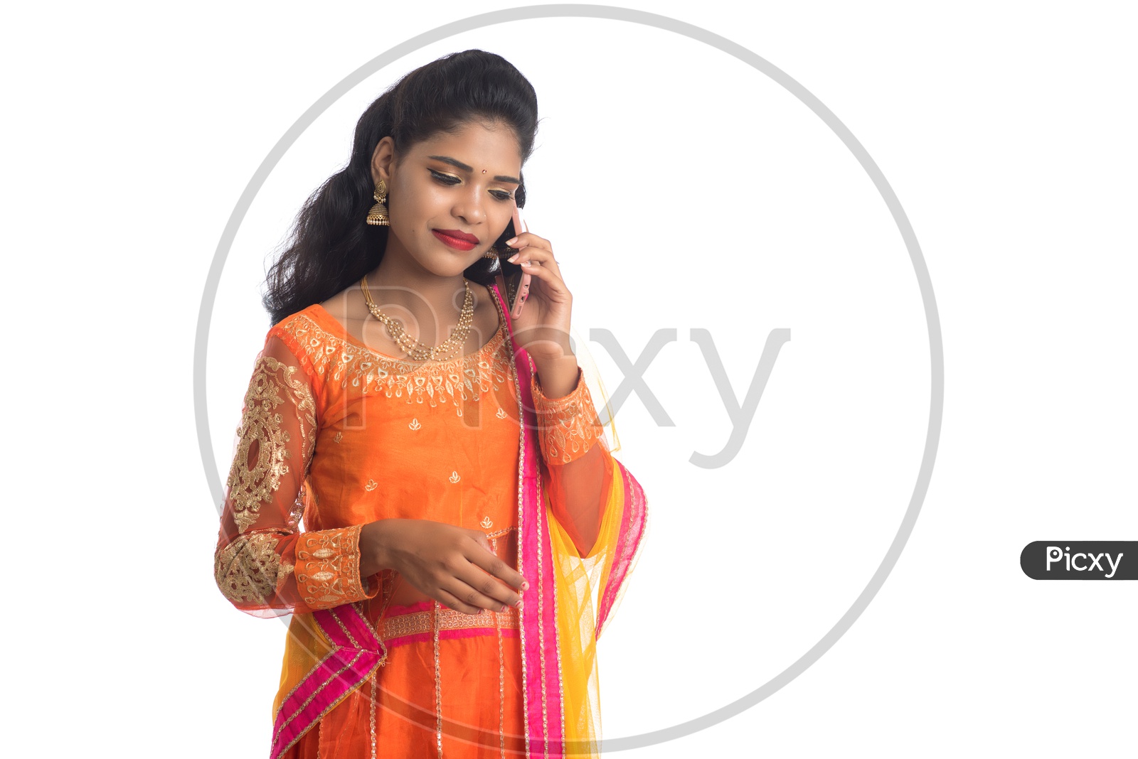 A Traditional Young Indian Woman Talking In Smart Phone And Posing On an Isolated White Background