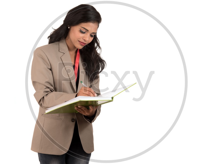 Indian business woman writing in a book