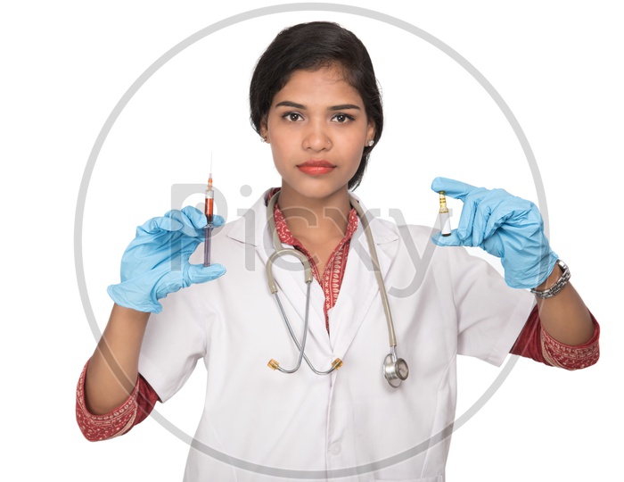 Indian Female Doctor with a loaded syringe and ample