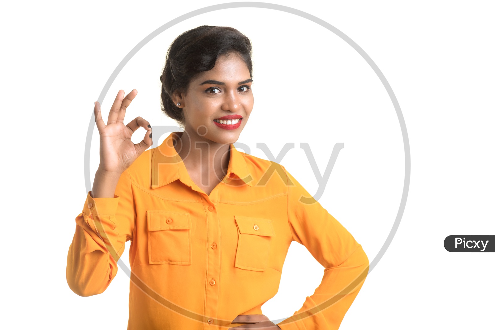 Indian woman wearing orange shirt making super sign