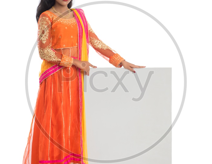 Young Traditional Indian Woman Holding Blank Board With Empty Space And Posing On an Isolated White Background