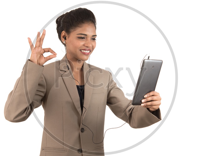 Young Indian business woman making a video call using tablet smartphone