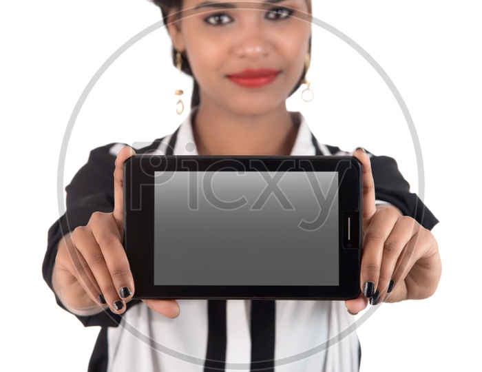 Young Indian Girl Showing Blank Smart Phone Screen and Pointing the Empty Space On an Isolated White Background