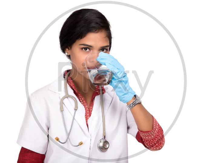 Indian Female Doctor drinking a glass of water