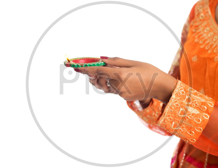 A young Indian woman holding diya in hand