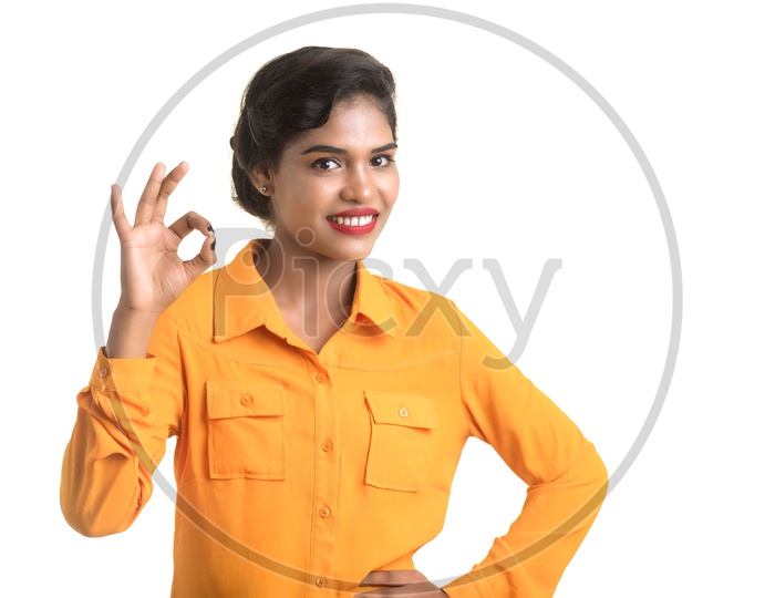 Indian woman wearing orange shirt making super sign