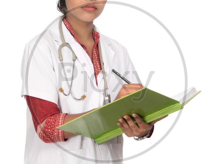 Young Lady Doctor With Stethoscope Over Neck And Writing In Book  On an Isolated White Background