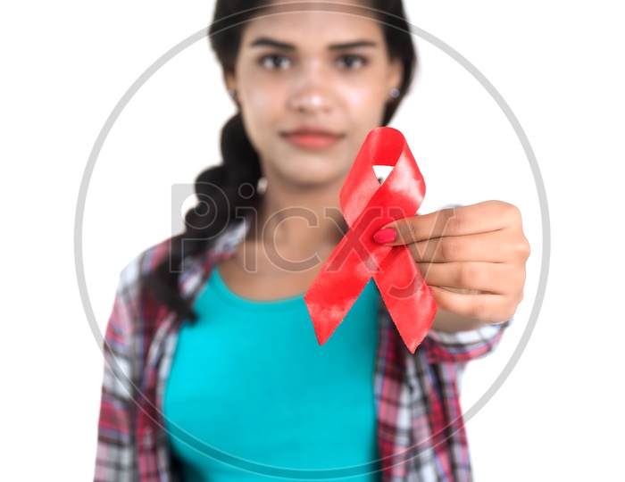 Young Woman Showing Red HIV Ribbon , AIDS Awareness Ribbon  on an  Isolated White Background
