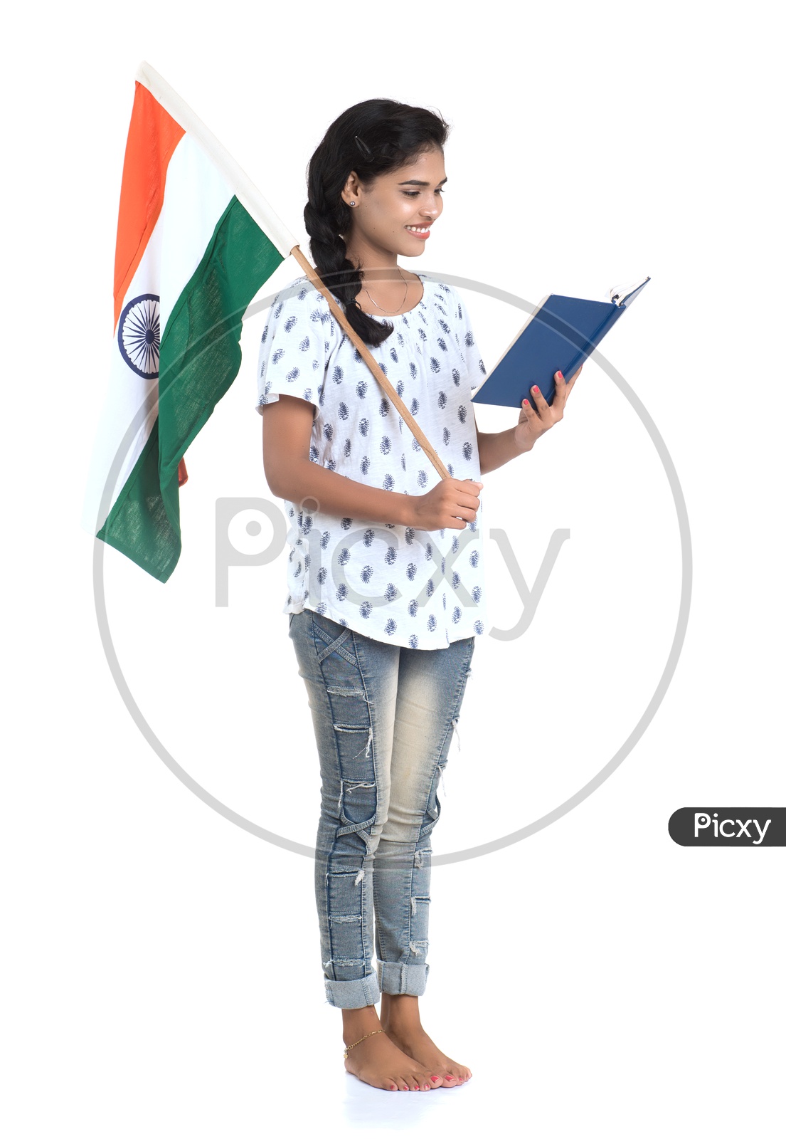 Young Indian Girl Holding Indian national Flag or Tri color Flag  and books in hands And Posing Over a White Background