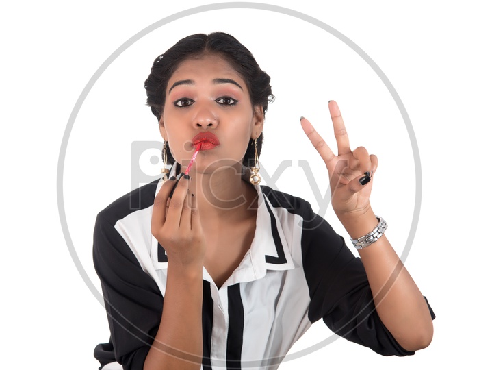 Young Indian Girl Putting On Lipstick with a Expression And Posing on White Background