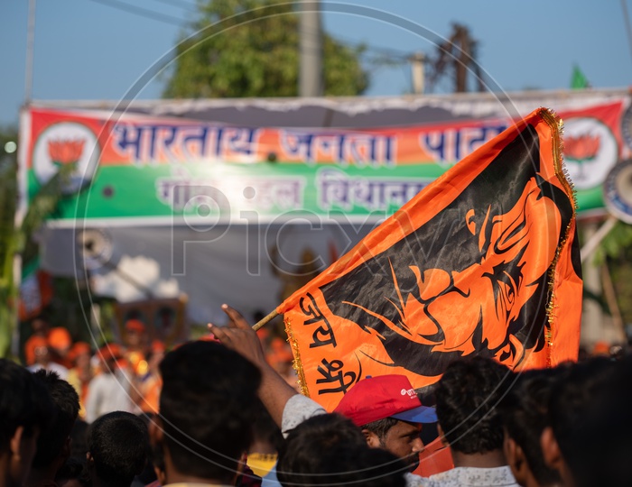 A man holding a saffron flag in a crowd at Shri Rama shobha yatra in Hyderabad
