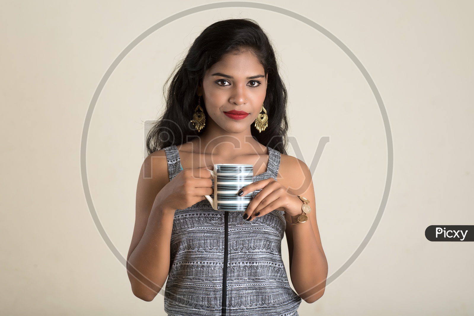 Indian woman holding a mug