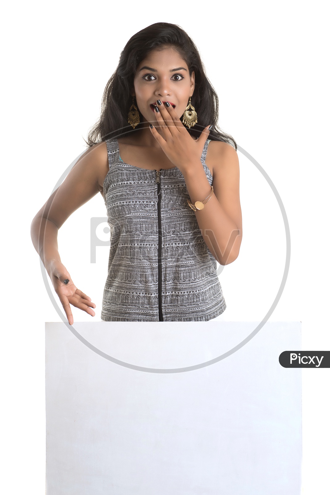 Indian woman with hand on her mouth