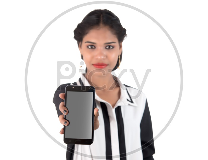 Image Of A Happy Young Indian Girl Using Smart Phone With A Smiling