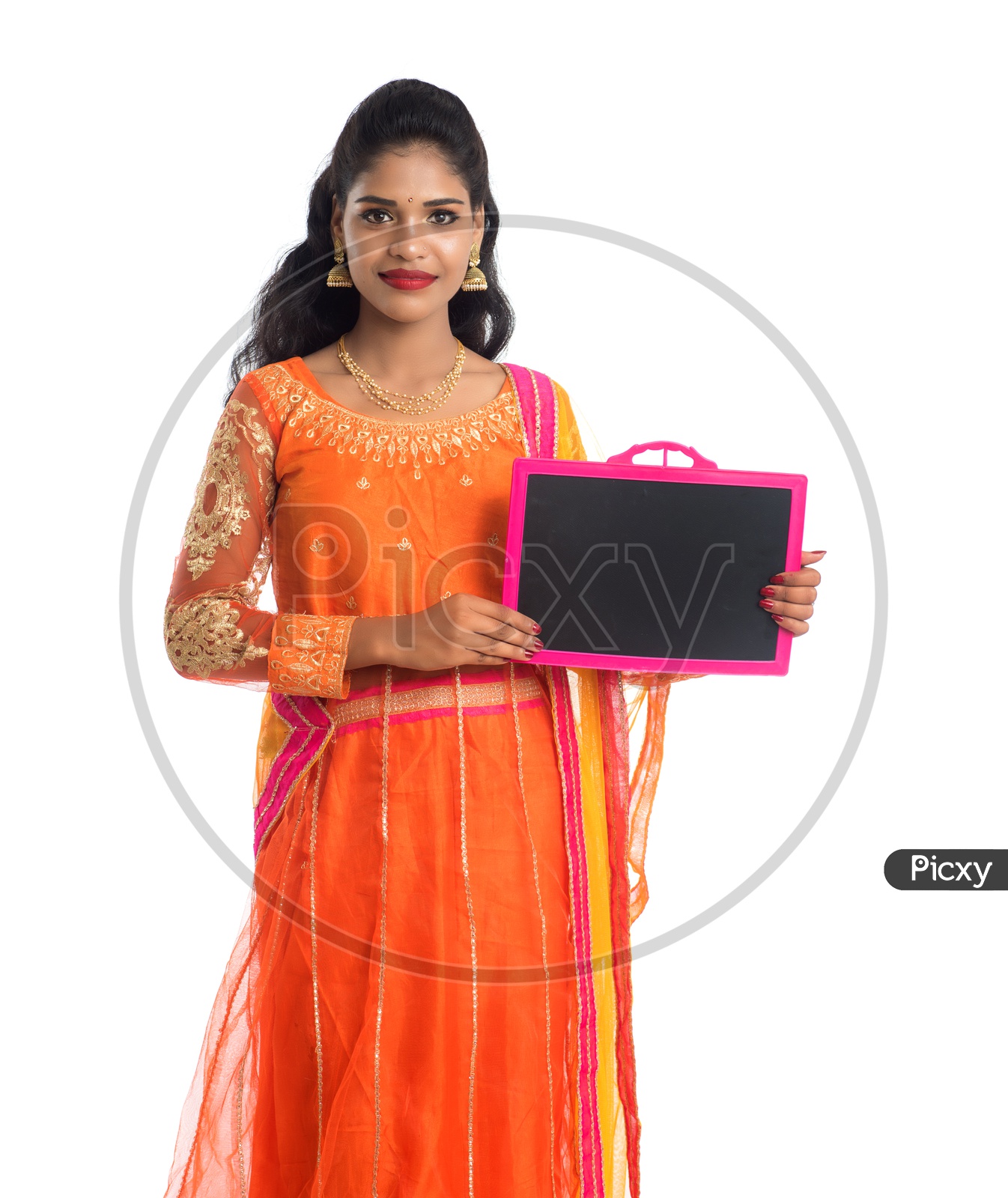 A Young traditional Indian Girl Holding a Blank Slate Board  And Showing The Space With Smile Face On an Isolated White Background