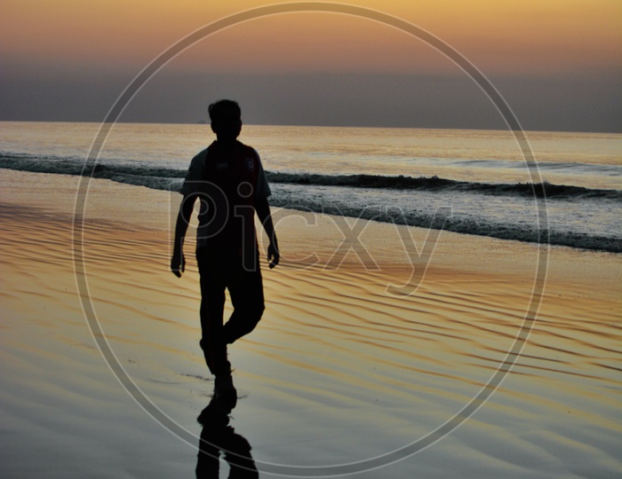 Silhouette Of a Man Walking In Beach