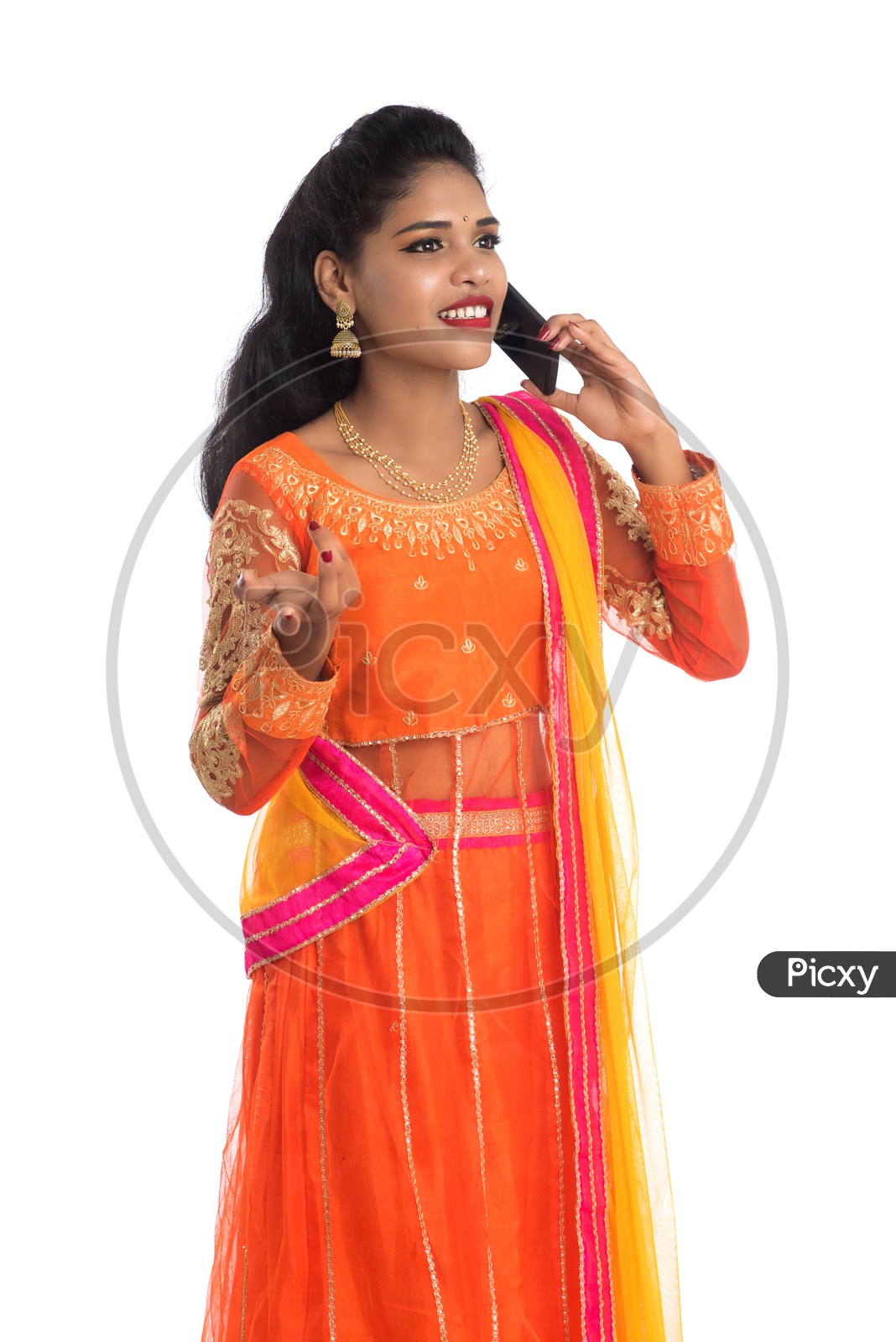 A young traditional Indian woman talking on a mobile phone or smart phone